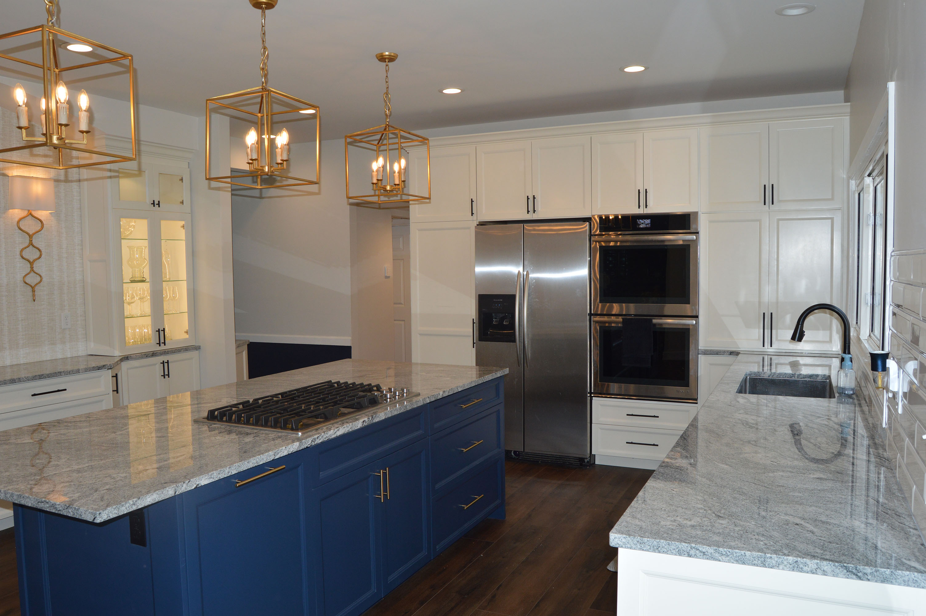 Kitchen design featuring statement blue island